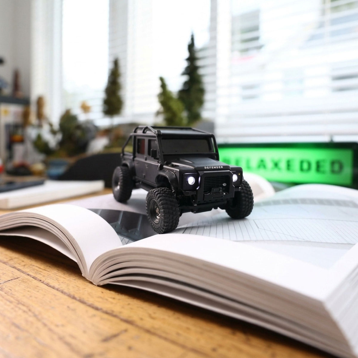 Licensed 1:43 Land Rover Defender 110 RC Crawler on a book