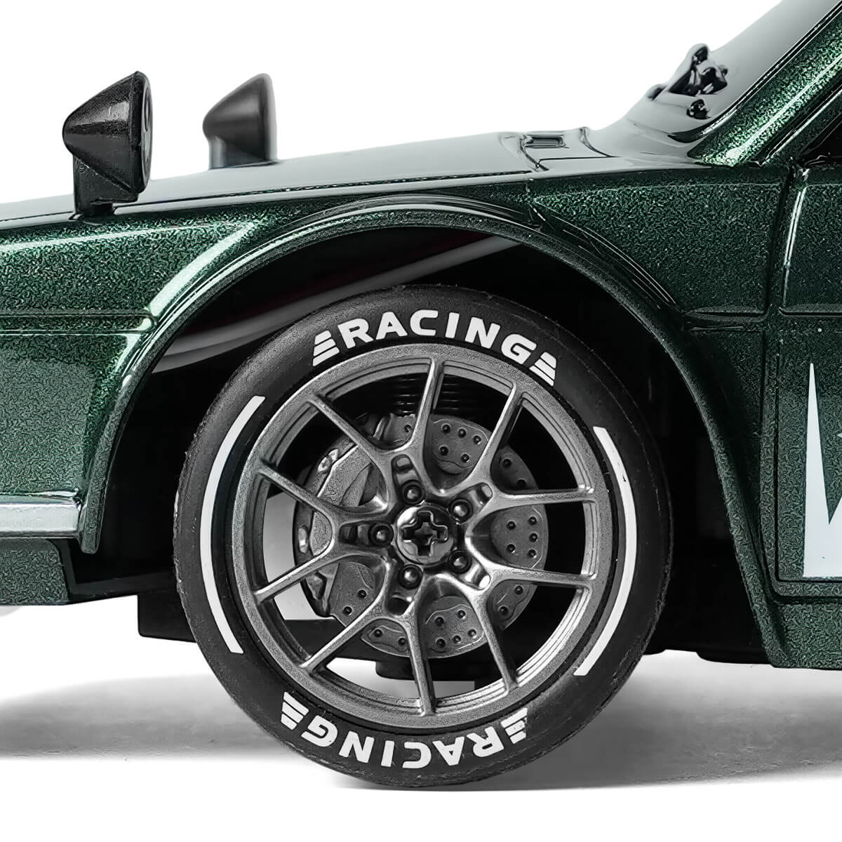 Close-up of 1/24 scale RC car silver wheel with simulated brake disc and racing tire details for BRRRRT drift car