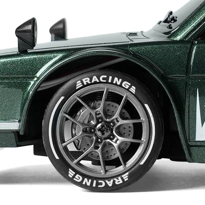 Close-up of 1/24 scale RC car silver wheel with simulated brake disc and racing tire details for BRRRRT drift car